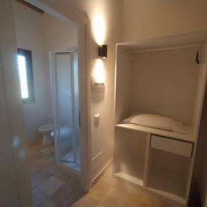 a bathroom with a toilet and a walk in closet at Luxardotel in Rome