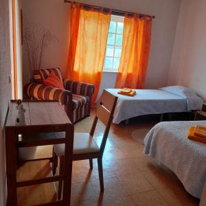 Zimmer mit einem Bett, einem Tisch und einem Sofa in der Unterkunft Quarto duplo em Foros de Salvaterra in Estanqueiro