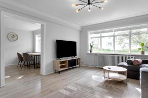 a living room with a couch and a flat screen tv at Lali Full Apartment in Reykjavík