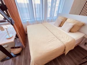a bed in a room with a large window at The Room - Direkt in der Stadt! in Bochum