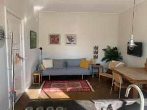 a living room with a blue couch and a table at B&B Amsterdam Amstel Apartment in Amsterdam