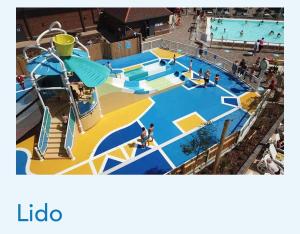 a large swimming pool with people at a water park at Seal Bay, West Sands in Selsey