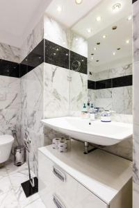 a white bathroom with a sink and a toilet at Casa Delle 5 Giornate di Milano in Milan +63 photos