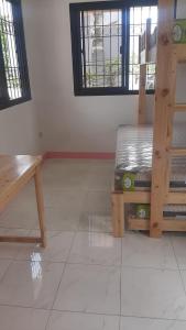 a room with a wooden bench and a window at Roseville Home Stay and Moroccan Spa and Wellness in Baranghauon