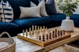 a chess board on a table in a living room at Hidden Gem Hideaway w/ Free Parking in Hough Green