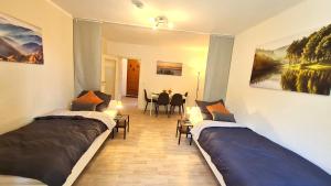 a room with two beds and a dining room with a table at Perfect Apartment in Unna close to Dortmund in Unna