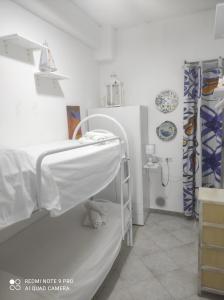 a hospital room with a bed and a sink at DA FEDERICA Casa Vacanze BAIA PORTO DELLE GENTI in Lipari