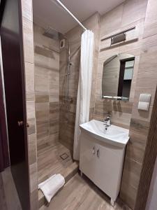 a bathroom with a sink and a shower at Noclegi Gambit Cieszyn 24h in Cieszyn