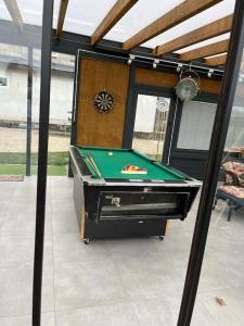 a pool table sitting inside of a room with at Cosy house with a big garden in the countryside in Gołaszewo