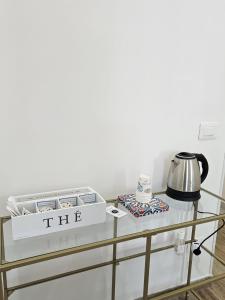 a glass table with a tea set on top of it at B&B Pietre Preziose in Salerno +40 photos