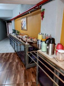 a kitchen with a bunch of food on the counters at Calabreza Hotel e Restaurante - By UP Hotel in Três Corações