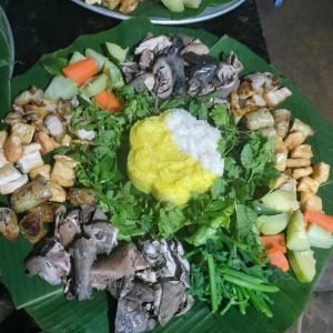 un plato de comida encima de una hoja de plátano en Đồng Văn Panorama Homestay en Dồng Văn