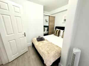a small bedroom with a bed and a door at Vibrant 2-Bedroom Flat with Elevator in Marylebone, Close to Hyde Park & Edgware Road in London