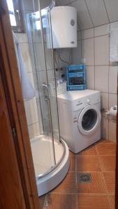a bathroom with a washing machine and a washer at Odmor in Šavnik +18 photos