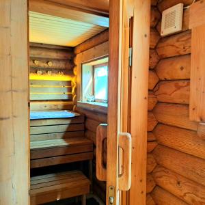 a sauna in a log cabin with a window at Lootuse Spa in Nõmmemaa