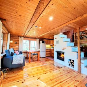 a living room with a couch and a fireplace at Lootuse Spa in Nõmmemaa