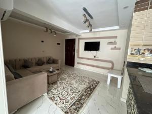 a living room with a couch and a tv at Apartment Hossam 1 in Hurghada