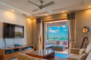 a living room with a view of the ocean at Beachfront Luxurious Stunning Sunset Boulevard Apartment, Grand Baie in Grand Baie