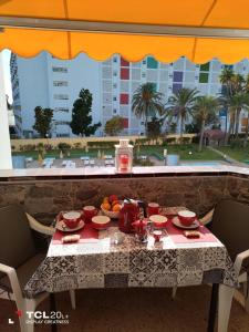 a table with food on it with a view of a city at Casa Maya in Maspalomas