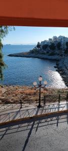 uma vista para uma massa de água a partir de uma janela em Sea Luxury Apartments em Piraeus