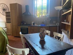 a kitchen with a table with a vase on it at CASA PANIERI in Rome