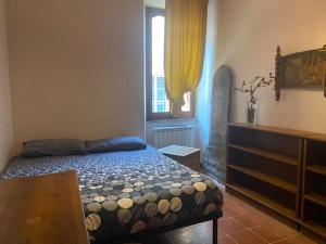 a bedroom with a bed and a dresser and a window at CASA PANIERI in Rome +8 photos