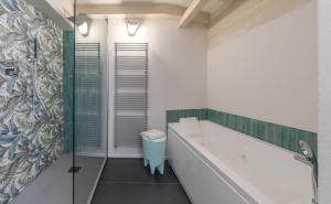 a bathroom with a bath tub and a shower at Fabroniana apartment Elegant in Pistoia