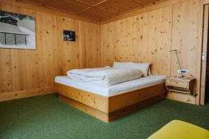a bedroom with a bed in a wooden room at Thurntaler Rast in Außervillgraten