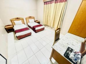 Postel nebo postele na pokoji v ubytování Al Ghadeer Hotel Apartment