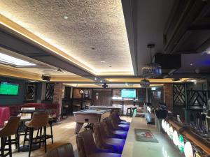 a bar with a pool table and chairs at Joyce's Carndonagh Inishowen in Carndonagh