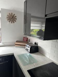a kitchen with a counter top with a toaster on it at The Coach House by Phoenix Premises - Hot Tub Fire Pit BBQ Log Burner Bar Games Room in Birmingham