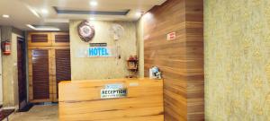a hotel lobby with a reception desk and wooden walls at Hotel Raj Residency in Bhopal
