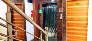 a metal door with a sign on it in a building at Hotel Raj Residency in Bhopal