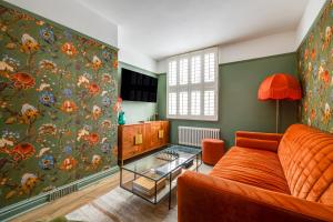a living room with a couch and a floral wallpaper at Insta-worthy Loft on Historic Chester Rows, Sleeps 4 & Free Parking in Chester