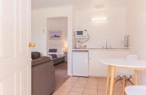 a kitchen with a couch and a table in a room at Penola Coonawarra Caravan Park in Penola