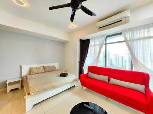 a bedroom with a red couch and a window at A3007 Grand Medini 100mbps Netflix By STAY in Nusajaya