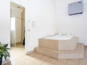 a bathroom with a bath tub in a room at 10 person holiday home in Grenaa in Grenå