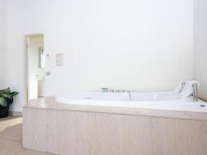 a bathroom with a large white tub in a room at 10 person holiday home in Grenaa in Grenå