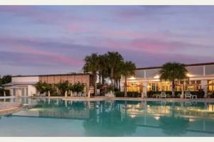 a large swimming pool in front of a building at FREE Amenities with Kids Waterpark in Luxury House in Davenport