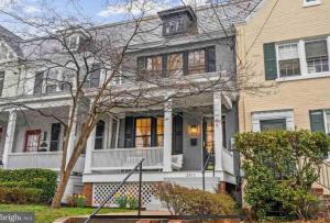 a large white house with a porch and a house at Glover Park/Georgetown Oasis with parking in Washington, D.C.