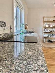 a kitchen with a sink and a counter top at Sunny apartment by the river in Kelso