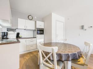 - une cuisine blanche avec une table et des chaises dans l'établissement Nouvella 2 bedrooms on floor 3, à Blankenberge