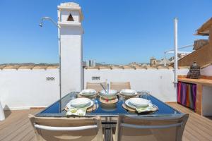 a table with dishes on it on a balcony at C20 - Adorable Apartment in the Center with Sun Terrace in Málaga