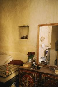 a bedroom with a mirror and a bed and a table at Baben Home in Siwa