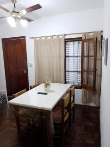 a dining room with a white table and chairs at Nono Angelo 3° in San Pedro +9 photos