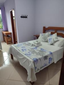 Cama ou camas em um quarto em Hotel Lumiar