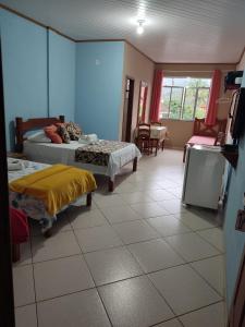 Cama ou camas em um quarto em Hotel Lumiar