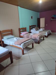 Cama ou camas em um quarto em Hotel Lumiar
