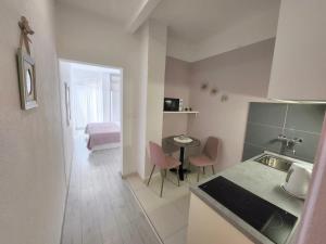 eine Küche mit einem Waschbecken und einem Tisch in einem Zimmer in der Unterkunft Apartments Talija Podgora in Podgora