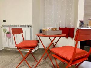 a table with two chairs and a table with a box on it at MareLuna Guest House in Naples +11 photos